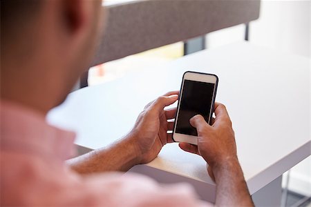 View Over The Shoulder Of Male Student Using Mobile Phone Stock Photo - Budget Royalty-Free & Subscription, Code: 400-08937937