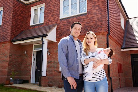 simsearch:400-08938320,k - Portrait Of Young Family Standing Outside New Home Stock Photo - Budget Royalty-Free & Subscription, Code: 400-08938256