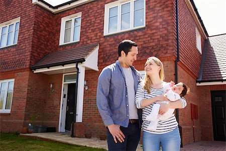 simsearch:400-08938320,k - Young Family Standing Outside New Home Stock Photo - Budget Royalty-Free & Subscription, Code: 400-08938257