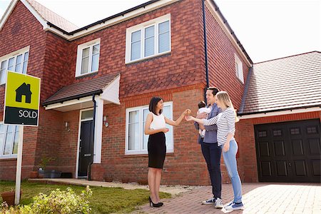 family with sold sign - Young Family Collecting Keys To New Home From Realtor Stock Photo - Budget Royalty-Free & Subscription, Code: 400-08938265