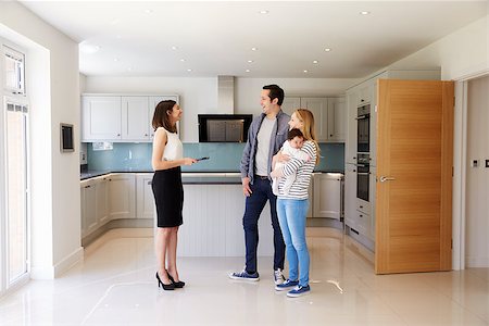 simsearch:400-08938320,k - Realtor Showing Young Family Around Property For Sale Stock Photo - Budget Royalty-Free & Subscription, Code: 400-08938317