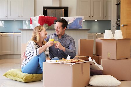 simsearch:400-08938320,k - Couple Celebrating Moving Into New Home With Pizza Stock Photo - Budget Royalty-Free & Subscription, Code: 400-08938323