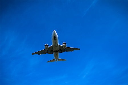 simsearch:400-08930740,k - Jet airplane flying overhead close-up on a blue sky background Stock Photo - Budget Royalty-Free & Subscription, Code: 400-08930740