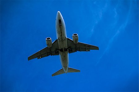 simsearch:400-08930740,k - Jet airplane flying overhead close-up on a blue sky background Stock Photo - Budget Royalty-Free & Subscription, Code: 400-08930741
