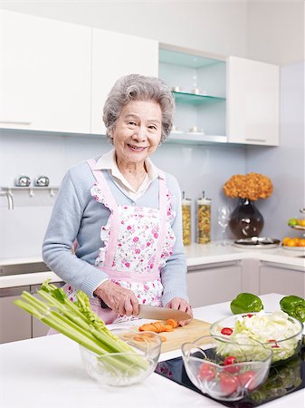 senior asian woman cutting carrot to make salad in kitchen. Stock Photo - Budget Royalty-Free & Subscription, Code: 400-08955810