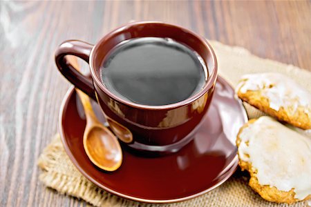 simsearch:400-06526962,k - Coffee in brown cup with biscuits pumpkin on a napkin from a sacking on a background of dark wood planks Foto de stock - Royalty-Free Super Valor e Assinatura, Número: 400-08956659