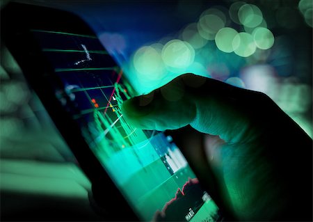 share data - A businessman checking stock charts on a mobile device. Technology and work on the go. Stock Photo - Budget Royalty-Free & Subscription, Code: 400-08956726