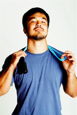 young asian guy with skipping rope on white background ready to training sport, lifestyle people concept in studio Stock Photo - Budget Royalty-Free & Subscription, Code: 400-08956857