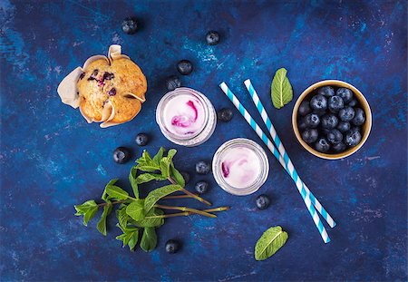 photos of blueberries for kitchen - Natural yogurt with fresh blueberries, mint and a muffin. Top view. Selective focus. Stock Photo - Budget Royalty-Free & Subscription, Code: 400-08964700