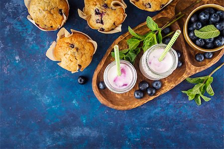 photos of blueberries for kitchen - Homemade muffins with blueberries and yogurt with mint. Food background with copy space. Top view. Selective focus. Stock Photo - Budget Royalty-Free & Subscription, Code: 400-08964701