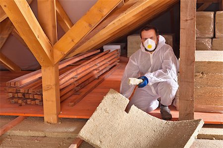 Man laying thermal insulation panels in a new house - under the roof Stock Photo - Budget Royalty-Free & Subscription, Code: 400-08964974