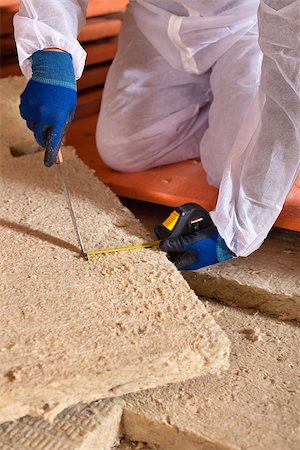 Man cutting rockwool panel to fit in thermal insulation layer - closeup on hands Stock Photo - Budget Royalty-Free & Subscription, Code: 400-08964975