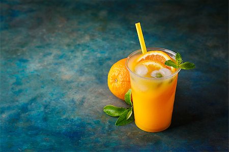 simsearch:400-05911768,k - Freshly squeezed orange juice with lemon and mint. Food background with copy space. Selective focus. Photographie de stock - Aubaine LD & Abonnement, Code: 400-08967161