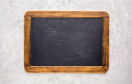 Small empty chalkboard on a light grey textured background. Blank. Blackboard Background. Blackboard texture Stock Photo - Budget Royalty-Free & Subscription, Code: 400-08962038