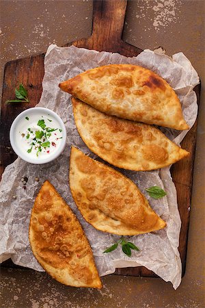 Traditional russian and caucasian pies - meat chebureks fried in oil. Stock Photo - Budget Royalty-Free & Subscription, Code: 400-08962039
