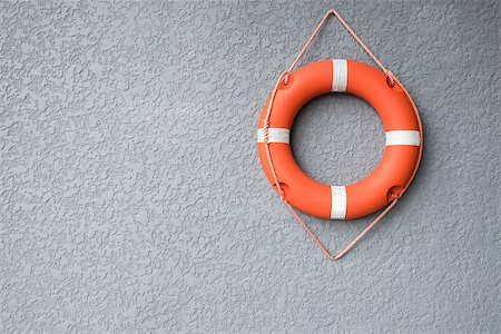 Orange life buoy hang on the grey wall Stock Photo - Budget Royalty-Free & Subscription, Code: 400-08978972