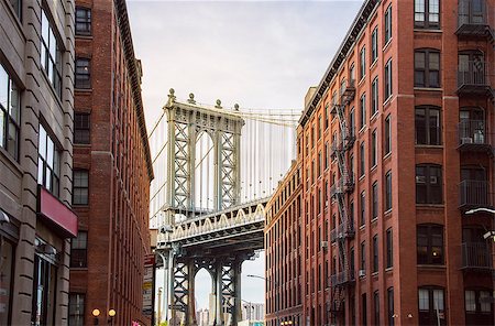 famous Manhattan Bridge between Manhattan and Brooklyn over East River seen from a narrow alley enclosed by two brick buildings on a sunny day, New York City Stock Photo - Budget Royalty-Free & Subscription, Code: 400-08979974