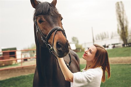 fashion horseback - Beautiful girl communicates with the horse in the park. Preparing for the riding Stock Photo - Budget Royalty-Free & Subscription, Code: 400-08980524