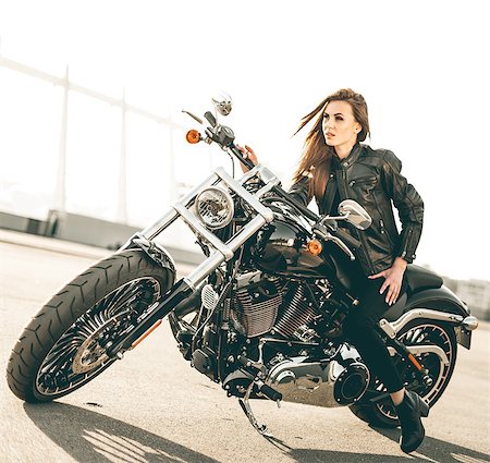 Girl on a motorcycle. She is beautiful, posing on a motorcycle at sunset Stock Photo - Budget Royalty-Free & Subscription, Code: 400-08980530