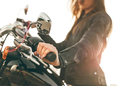 Girl on a motorcycle. She is beautiful, posing on a motorcycle at sunset Stock Photo - Budget Royalty-Free & Subscription, Code: 400-08980869