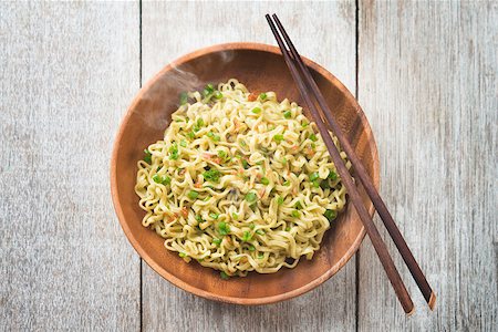 simsearch:400-05297094,k - Top view cooked Japanese ramen dried noodles with chopsticks on wooden table. Fotografie stock - Microstock e Abbonamento, Codice: 400-08996879