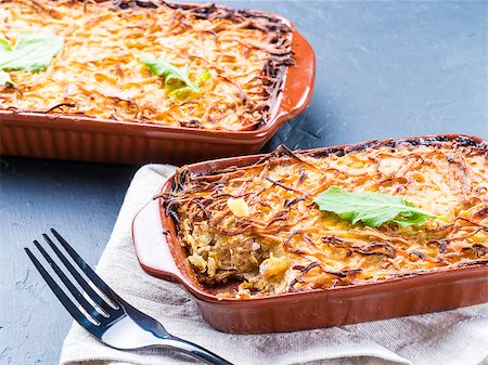 simsearch:400-08695789,k - Close up view of appetizing potato casserole with fish, eggs and cream. Potato casserole in serving baking dish on dark concrete background Stock Photo - Budget Royalty-Free & Subscription, Code: 400-08997122