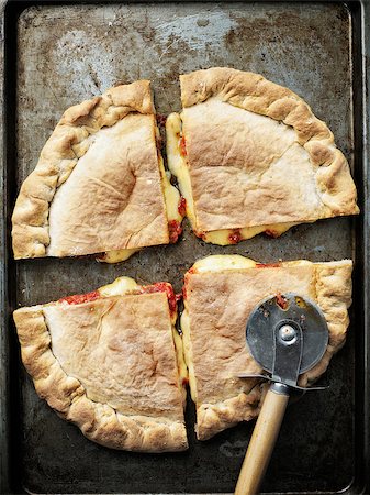 close up of rustic italian calzone stuffed pizza Stock Photo - Budget Royalty-Free & Subscription, Code: 400-08997214