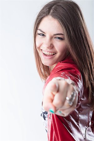 girl in braces laughing lovely and pointing out her index finger, meaning she has choosen you Stock Photo - Budget Royalty-Free & Subscription, Code: 400-09008439