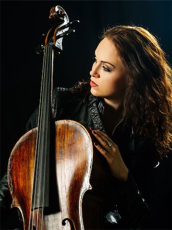 Photo of a beautiful woman posing with her old cello. Stock Photo - Budget Royalty-Free & Subscription, Code: 400-09008523