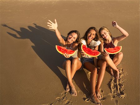 pictures of people eating watermelon on the beach - Best friends having fun on the beach and eating watermelon Stock Photo - Budget Royalty-Free & Subscription, Code: 400-09008925