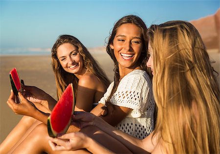 pictures of people eating watermelon on the beach - Best friends having fun on the beach and eating watermelon Stock Photo - Budget Royalty-Free & Subscription, Code: 400-09009191