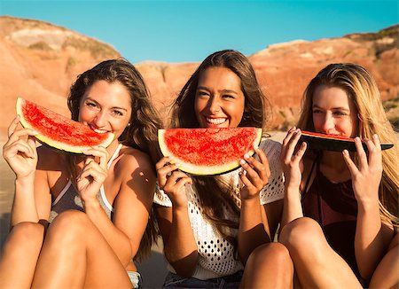 pictures of people eating watermelon on the beach - Best friends having fun on the beach and eating watermelon Stock Photo - Budget Royalty-Free & Subscription, Code: 400-09009192