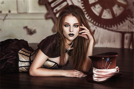 Portrait of a beautiful steampunk woman near big clock Stock Photo - Budget Royalty-Free & Subscription, Code: 400-09009401