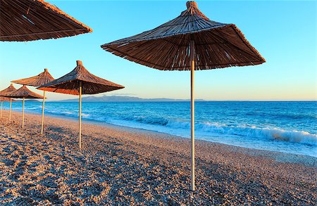 simsearch:400-09011314,k - Summer sunset beach with strawy sunshades (Albania). Stockbilder - Microstock & Abonnement, Bildnummer: 400-09009481
