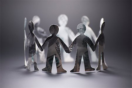 paper cutout chain - people origami from the banknote holding hands Stock Photo - Budget Royalty-Free & Subscription, Code: 400-09009569