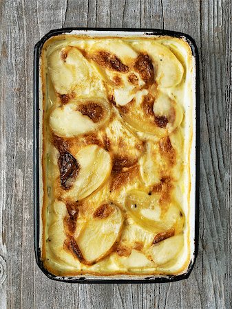 simsearch:400-08695789,k - close up of rustic golden scalloped potato gratin dauphinois Stock Photo - Budget Royalty-Free & Subscription, Code: 400-09000449