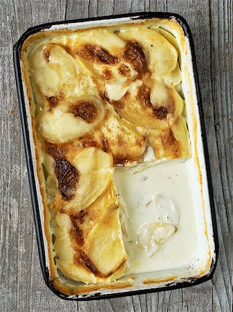 simsearch:400-08695789,k - close up of rustic golden scalloped potato gratin dauphinois Stock Photo - Budget Royalty-Free & Subscription, Code: 400-09000937