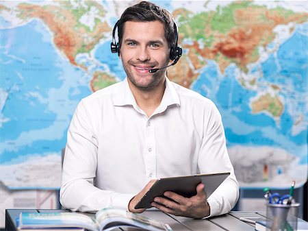 Young man tour agent sitting in office Stock Photo - Budget Royalty-Free & Subscription, Code: 400-09019086