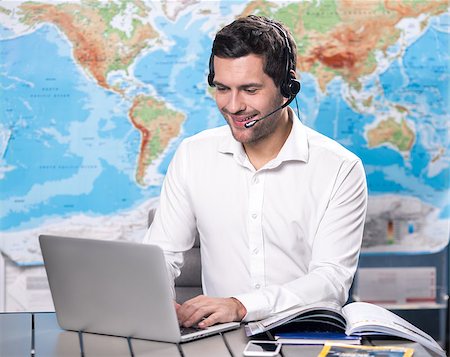 Young man tour agent sitting in office Stock Photo - Budget Royalty-Free & Subscription, Code: 400-09019087