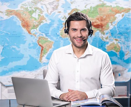 Young man tour agent sitting in office Stock Photo - Budget Royalty-Free & Subscription, Code: 400-09019088