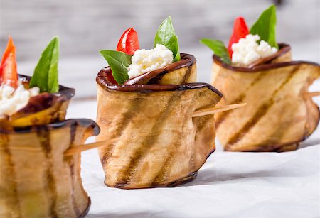 delicious Eggplant Rolls with feta cheese, tomato and basil leaves, close-up Stock Photo - Budget Royalty-Free & Subscription, Code: 400-09019171