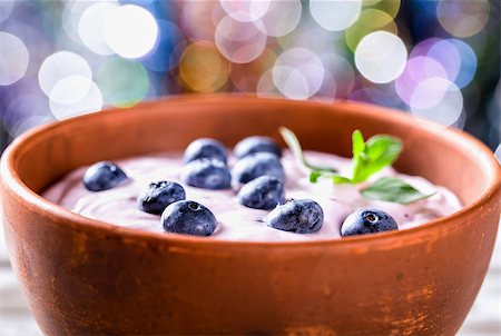 yogurt with blueberries and mint, bokeh background. selective focus, closeup Stock Photo - Budget Royalty-Free & Subscription, Code: 400-09019313