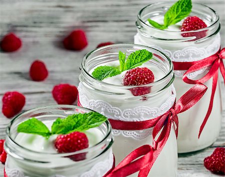 tasty yogurt with raspberries and mint in a glass jars, selective focus, macrro Stock Photo - Budget Royalty-Free & Subscription, Code: 400-09019330