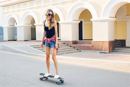 summer holidays, extreme sport and people concept - happy girl riding skateboard on city street. Stock Photo - Budget Royalty-Free & Subscription, Code: 400-09019549