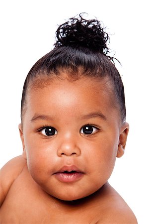 Face of beautiful cute baby toddler with hair in bun. Foto de stock - Super Valor sin royalties y Suscripción, Código: 400-09019607