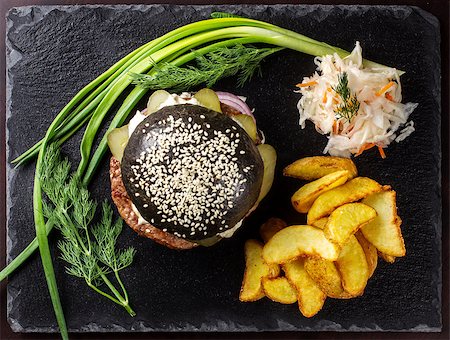 simsearch:400-07817174,k - Black hamburger on stone table with black background. Fastfood meal. Delicious Hamburger. Top view. Foto de stock - Super Valor sin royalties y Suscripción, Código: 400-09019660