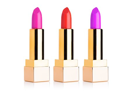 Golden containers of luxury cosmetic lipstick different colors on white background Stock Photo - Budget Royalty-Free & Subscription, Code: 400-09019700