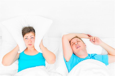 woman can not sleep from snoring husband, the pillow covering her ears Stock Photo - Budget Royalty-Free & Subscription, Code: 400-09010082