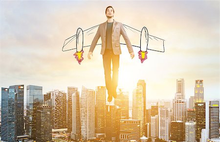 Business Advantage. Businessman with sketch wings hovering over down town on sunset. Stock Photo - Budget Royalty-Free & Subscription, Code: 400-09010294