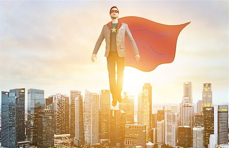 Business superhero. Businessman in sketch super hero suit hovering over down town on sunset. Stock Photo - Budget Royalty-Free & Subscription, Code: 400-09010296